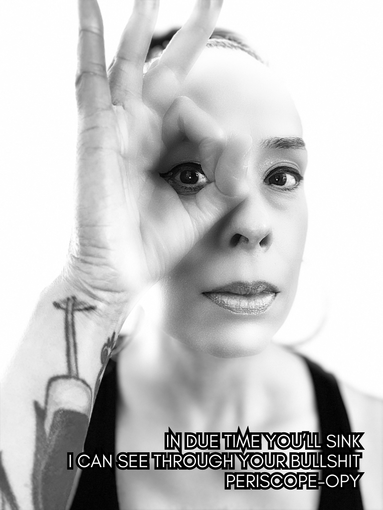 Black and white close-up self-portrait of Baroque Medusa forming a circle with her hand over one eye