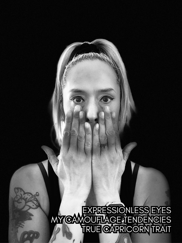Black and white self-portrait of Baroque Medusa covering her mouth with both hands, eyes exposed against a dark background