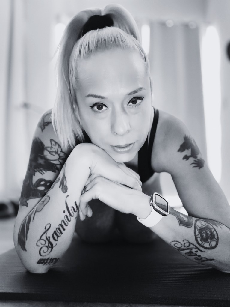 Baroque Medusa author portrait in inflatable pool wearing sunglasses and colorful swimwear, platinum blonde hair, contemporary indie fiction writer