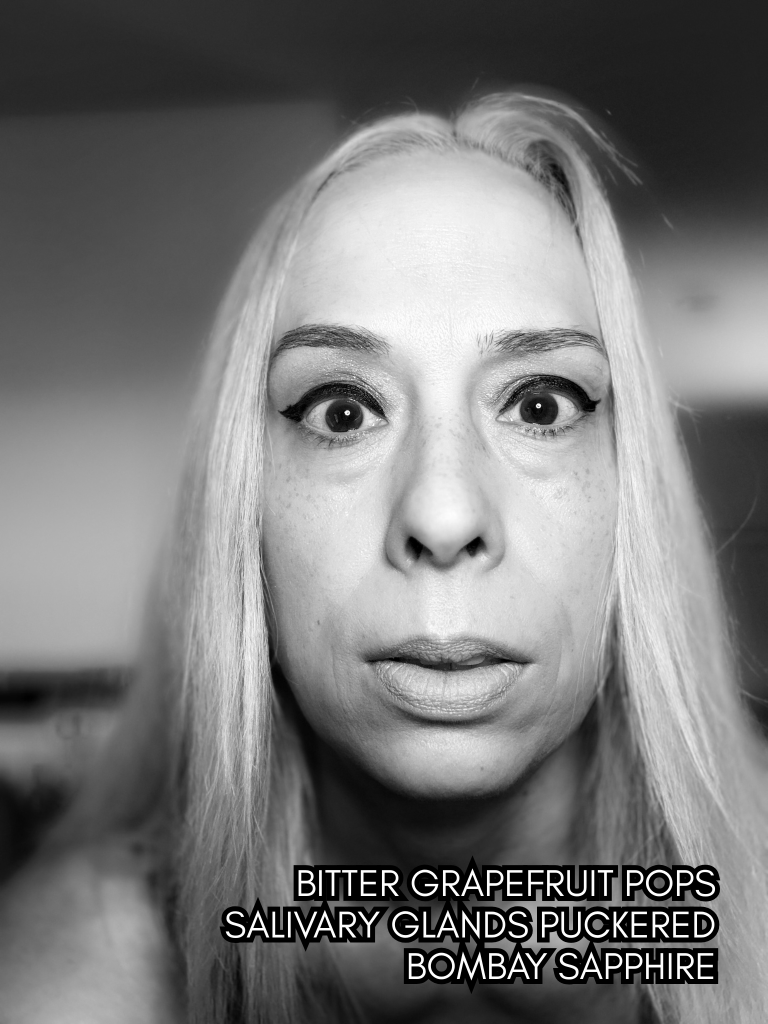 High-contrast black-and-white portrait of Baroque Medusa staring wide-eyed at the camera, overlaid with a haiku referencing bitterness, grapefruit, and sharp sensation.