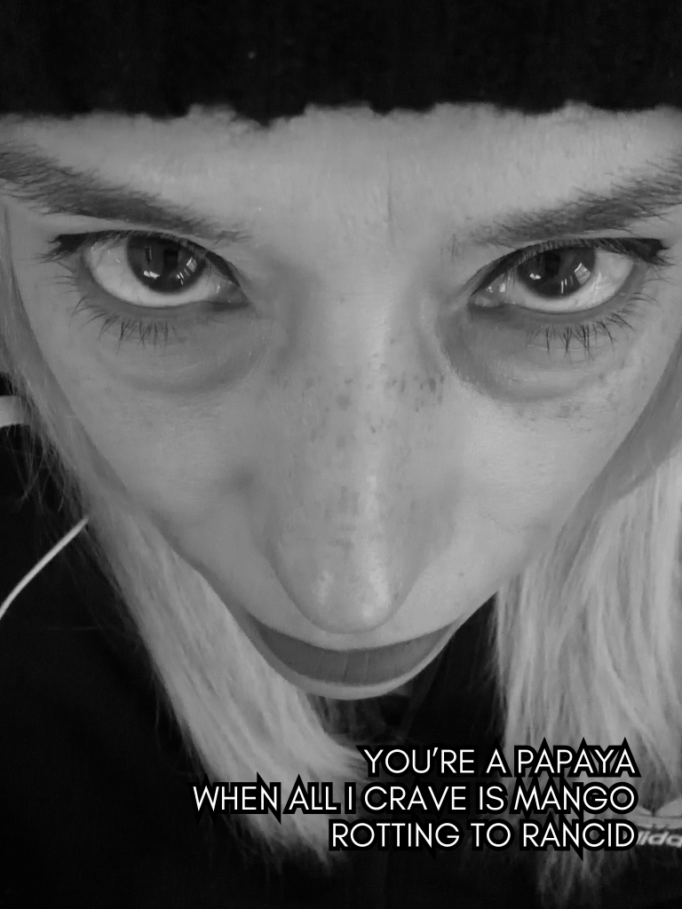 High-contrast black-and-white close-up of Baroque Medusa’s face with direct eye contact and haiku text overlay.