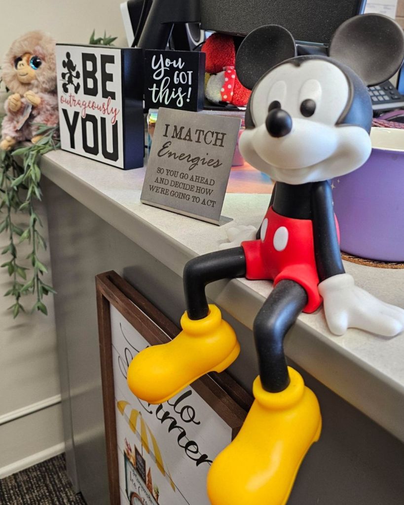 Mickey Mouse figure sitting on an office counter, submitted through Baroque Medusa’s Instagram camera roll call and used in It’s a Small Dystopian World.