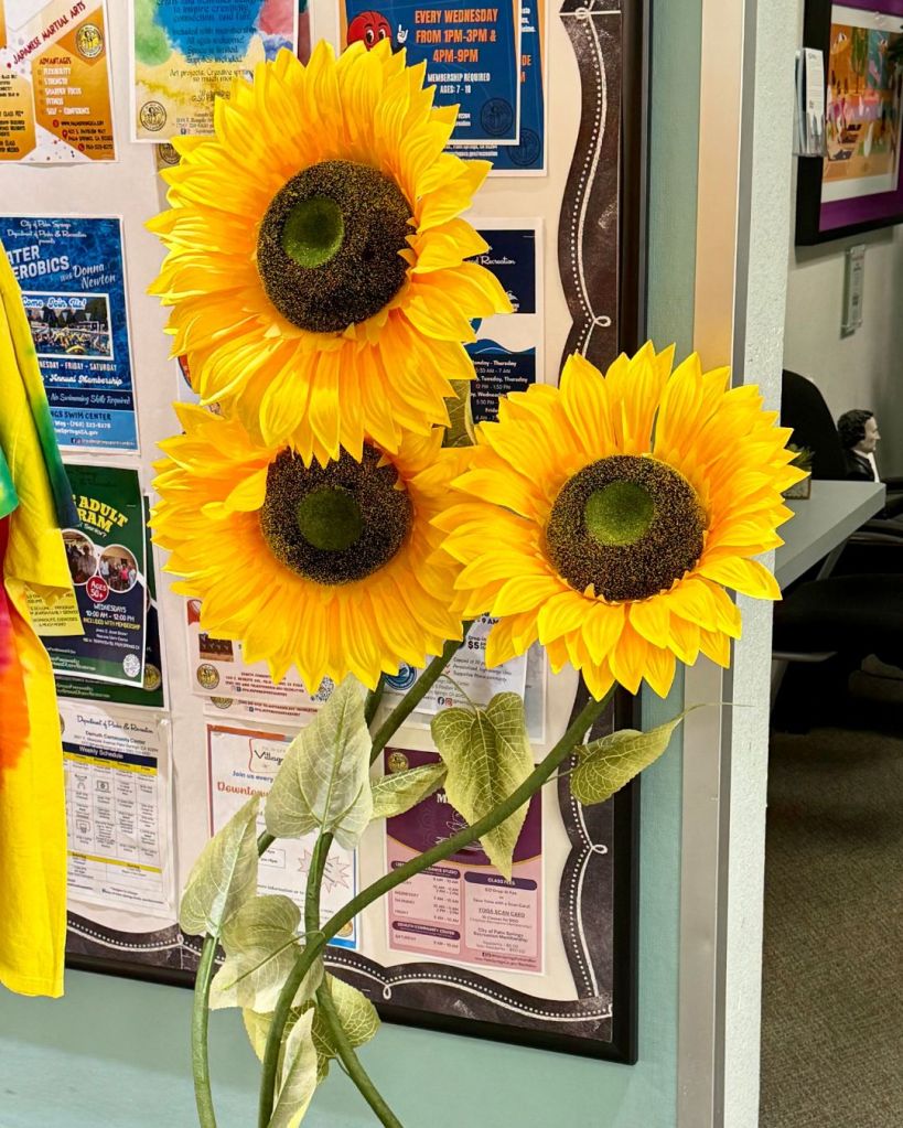 Three oversized yellow sunflowers photographed at the Palm Springs Pavilion and later digitally altered for It’s a Small Dystopian World.
